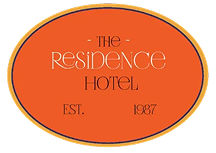 The Residence Hotel logo with orange oval background and white text