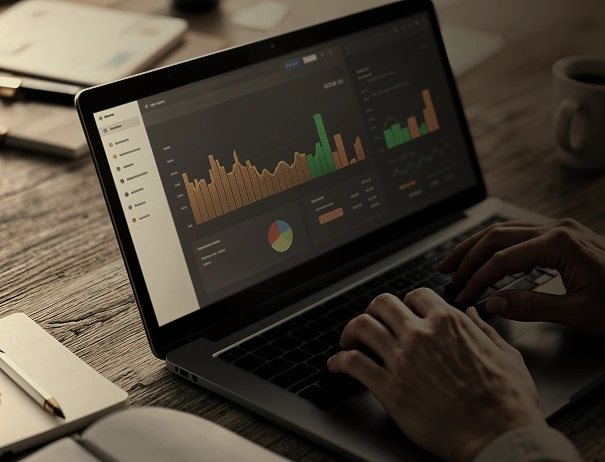 Person analyzing data dashboard on laptop with charts and graphs